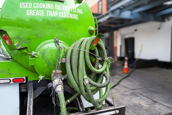 heavy-duty vacuum truck pumping out a grease trap in Frankfort NY